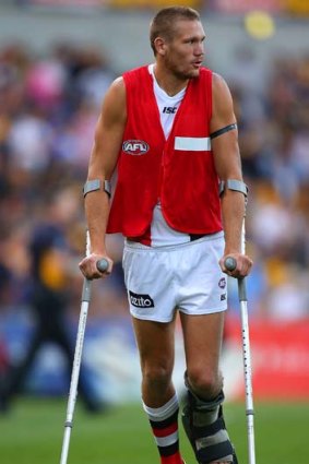 Sam Gilbert heads to the change rooms on crutches at the half-time break during the match against West Coast on Saturday.