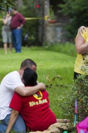 Neighbours embrace each other following a shooting in Houston, Texas.