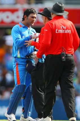 M.S Dhoni talks with umpires after Hussey was called back to the crease.