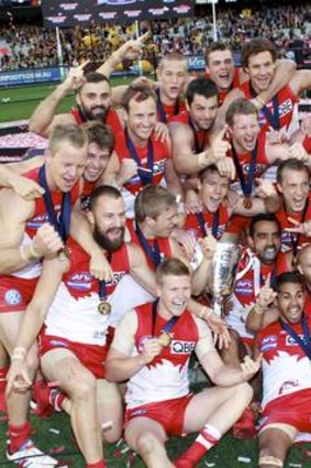 Swans players celebrate after winning the Premiership.