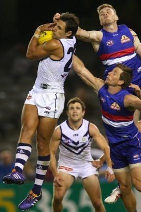 Strong grab: Matthew Pavlich marks in front of Jordan Roughead of the Western Bulldogs.