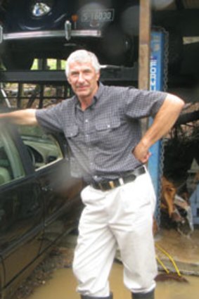 Terry Freeman with his flood-damaged Merceds Benz