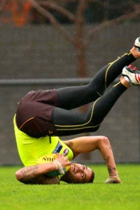 Back for more: Lance Franklin takes a tumble at Hawthorn training.