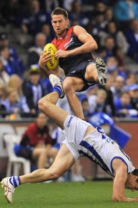 Demon on the rise: Melbourne’s Jeremy Howe marks over North’s Scott Thompson at Etihad Stadium yesterday.
