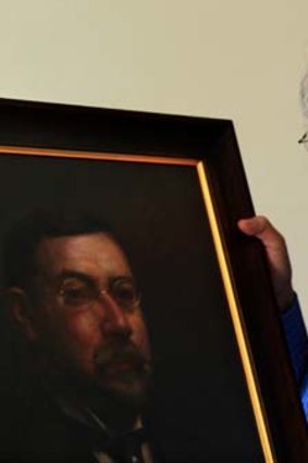 Academic Graham de Vahl Davis and an oil painting of his grandfather, Abraham de Vahl Davis.