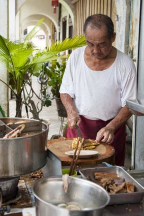 A vendor preparing food at Tai Buan in Penang.