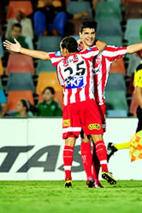 Eli Babalj snares Heart's first goal last night and celebrates with Adrian Zahra.