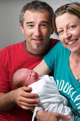 Proud parents Michael Cauchi and Peta Boyle with their newborn son Max, the first child born in Victoria in 2014.