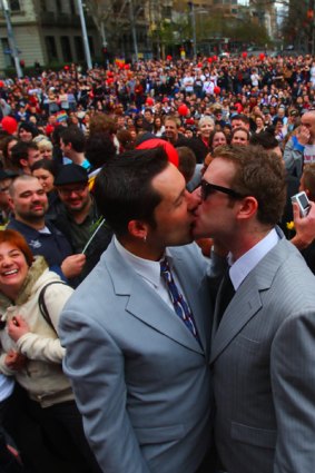 Damien Stevens (left) and Chris Todd celebrate their unofficial marriage with thousands in Spring Street.