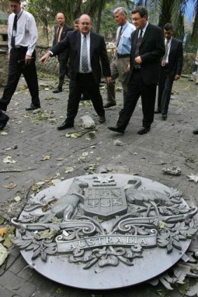 Australia's then Foreign Minister Alexander Downer inspects the damage with Ambassador David Ritchie.