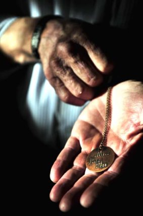 Time to remember: Hugh Poate wears son Robert's dogtags.