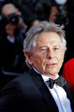 Director Roman Polanski and his wife and cast member Emmanuelle Seigner pose on the red carpet as they arrive for the screening of the film 'La Venus a la Fourrure' (<em>Venus in Fur</em>) during the 66th Cannes Film Festival.