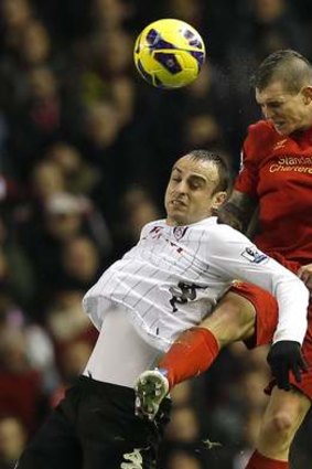 Liverpool's Daniel Agger (right) challenges Fulham's Dimitar Berbatov.