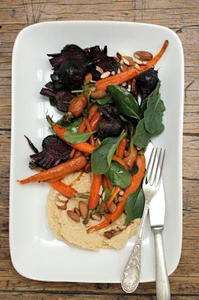 Roasted baby vegetables with hummus and roasted almonds.