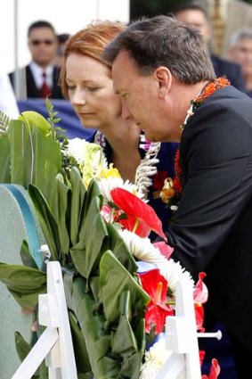 Julia Gillard and her partner Tim Mathieson lay a wreath at a ceremony marking Remembrance day at the National Cemetery of the Pacific in Honolulu, Hawaii.