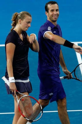 Petra Kvitova and Radek Stepanek of the Czech Republic talk inbetween games in the mixed doubles match against Alize Cornet and Jo-Wilfried Tsonga of France.