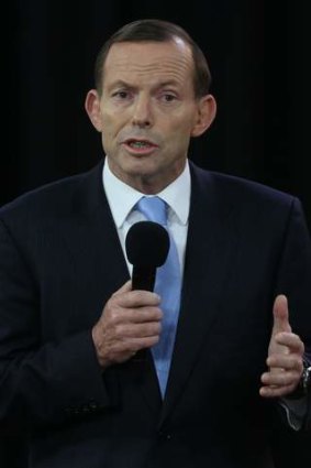Unwavering: Tony Abbott defends his budget management plans at Rooty Hill RSL despite relentless queries from Kevin Rudd.