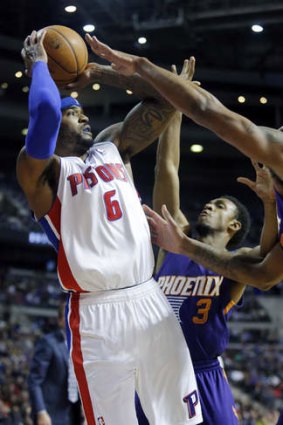 Detroit Pistons forward Josh Smith takes a shot against Phoenix Suns guard Ish Smith in Auburn Hills, Michigan. Smith scored 25 points, including the game winning basket, in a 110-108 win.