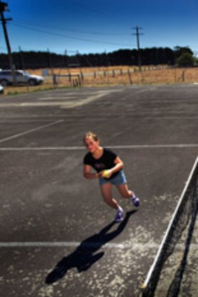 Virginia Wallace with her daughter Stella, 4, on the rundown tennis court at Cororooke, near Colac.