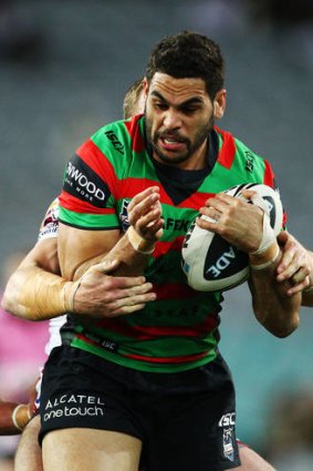 Greg Inglis of the Rabbitohs forces his way through a tackle.