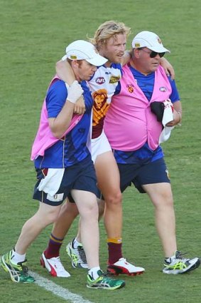 Sidelined: Daniel Rich is helped off the field on Saturday. He requires a knee reconstruction.
