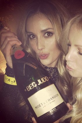 Rebecca Judd celebrated with a personalised bottle of Champagne at her husband's nightclub opening.
