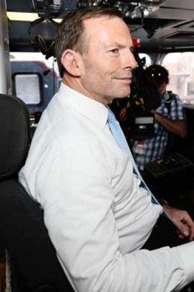 Tony Abbott tries the captain's chair on HMAS Maryborough.