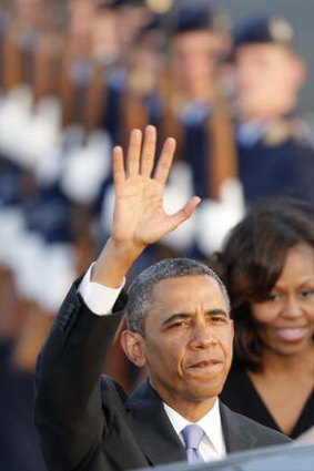 Nuclear cutbacks: Barack Obama waves after disembarking from Air Force One at the Tegel airport in Berlin on Tuesday.