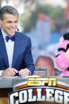 Football fan ... Katy Perry, right, joins host Chris Fowler, left, during telecast of ESPN's <i>College GameDay</i>.