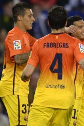 Barcelona's Cristian Tello (left), Pedro Rodriguez (second right) and Xavi Hernandez (right) celebrate after Rodriguez scored what turned out to be the match-winner against Espanyol.