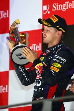 That looks good... Sebastian Vettel has a look at the silverware he won.