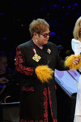 Meryl Streep performs at a benefit concert with Elton John and Sting.