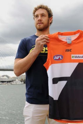 Star signing: Shane Mumford poses with a Greater Western Sydney jersey at the ANZAC Bridge.