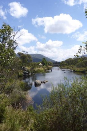 Bullocks Hut on the banks of a tranquil stretch of the Thredbo River.
