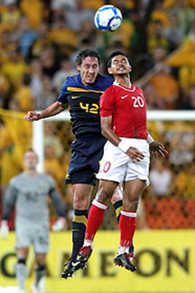 Socceroo Mark Milligan and Bambang Pamungkas go for the ball last night.