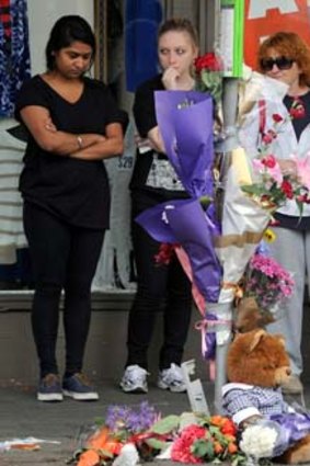 Sasha Nagarajan (left) and mourners at the spot where schoolgirl Jessalyn Leong was killed.