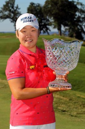 Jiyai Shin holds the championship trophy after winning the Kingsmill Championship.
