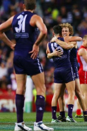 Ryan Crowley and Chris Mayne of the Dockers celebrate their win.