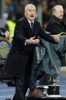 Testing times: France's coach Didier Deschamps attempts to encourage his players during their loss to Ukraine.
