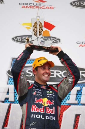 Jamie Whincup holds his trophy aloft after winning round five of the V8 Supercar Championship Series at Circuit of The Americas in Austin, Texas.
