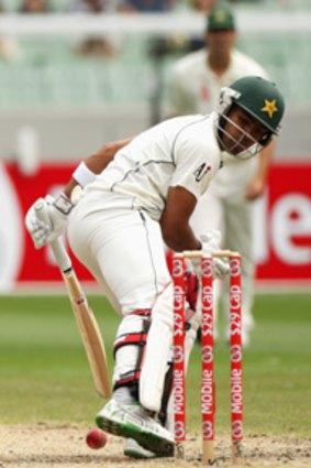 Umar Akmal looks to kick the ball away from his stumps.