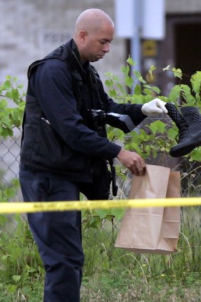 Seven shot ... a Detroit police officer gathers evidence.