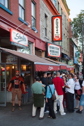 Crowds gather for smoked meats at Schwartz’s in Montréal.