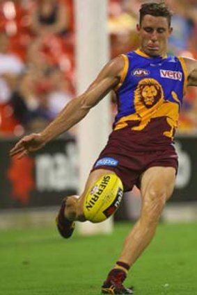 James Polkinghorne of the Lions sends the ball upfield during the match against the Gold Coast Suns.