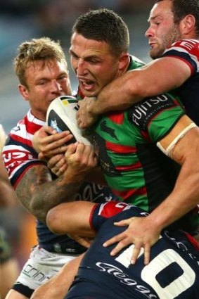 Burgess charges into several Roosters on Friday night.