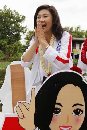 Puea Thai Party's Yingluck Shinawatra greets her supporters during the election campaign.