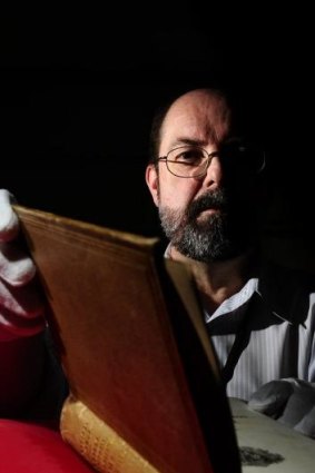  Andrew Sergeant, rare books reference librarian at the Australian National Library, with a book covered in human skin.  