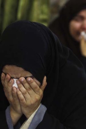 Tears for the dead: Relatives of dead members of the Muslim Brotherhood cry at a mosque in Cairo.