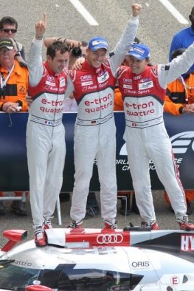 The Audi R18 e-tron quattro team, (from left) France's Benoit Treluyer, Germany's Andre Lotterer and Switzerland's Marcel Fassler, celebrate their win at the 82nd Le Mans endurance race on Sunday.