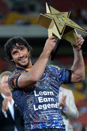 "More than a game of football": Johnathan Thurston lifts the Arthur Beetson trophy.